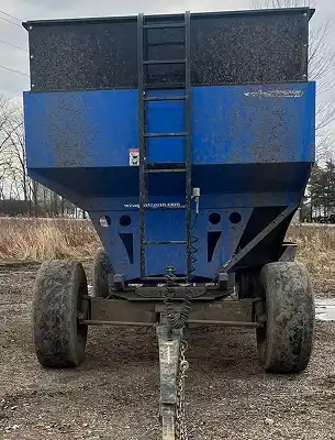 dirty grain trailer with dirt and grass smeared on