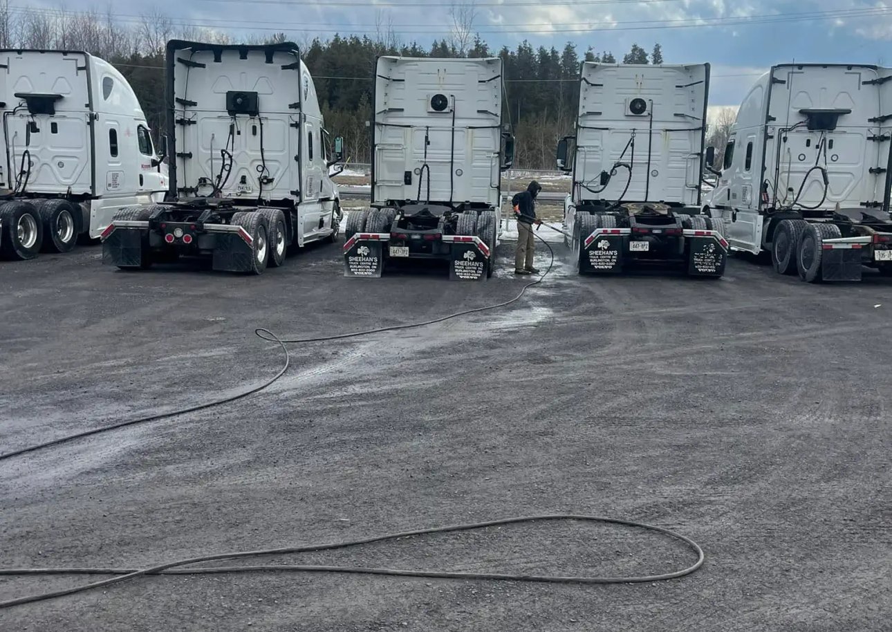 fleet of transport vehicles being pressure washed