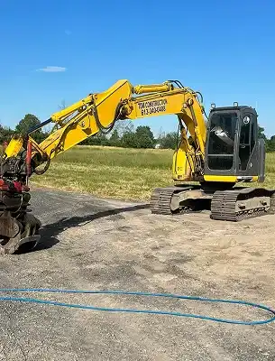 dirty excavator with dirt, grease and grass smeared on